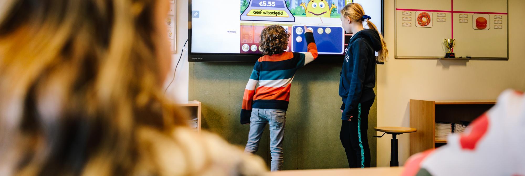 Twee kinderen werken samen aan smartbord
